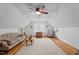Bright living room with wood floors, area rug, and pitched ceiling with fan at 6517 Hidden Pond Rd, Wendell, NC 27591