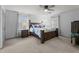 Main bedroom featuring ensuite, plush carpets, and large windows at 6517 Hidden Pond Rd, Wendell, NC 27591