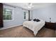 Inviting bedroom with plush carpeting, two windows, and a ceiling fan at 6565 New Market Way, Raleigh, NC 27615