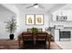 Well-lit dining area with modern white kitchen and lovely hardwood floors at 6565 New Market Way, Raleigh, NC 27615