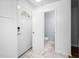 Bright entryway with marble floors, white walls, digital lock, and half bath off foyer at 6565 New Market Way, Raleigh, NC 27615