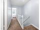 Upstairs hallway with carpet flooring leading to bedrooms with white trim and light blue walls at 6565 New Market Way, Raleigh, NC 27615