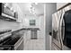 Updated kitchen features white cabinets, stainless appliances and stylish black marble countertops at 6565 New Market Way, Raleigh, NC 27615