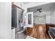 Stainless steel refrigerator near a doorway, with a glimpse into a living room with hardwood floors at 6565 New Market Way, Raleigh, NC 27615
