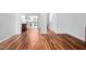 Living room featuring a hardwood floor and an open view of the kitchen and staircase at 6565 New Market Way, Raleigh, NC 27615