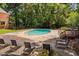 Community pool with chairs and a deck surrounded by trees and lawn at 6565 New Market Way, Raleigh, NC 27615