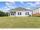 Rear exterior of home showcasing a large yard and back patio at 680 Winesap Dr, Graham, NC 27253