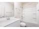 Well-lit bathroom with a shower-tub combo and a vanity sink with mirror at 680 Winesap Dr, Graham, NC 27253
