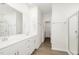 Bright bathroom featuring a double sink vanity, tile floors, and a glass-enclosed shower at 680 Winesap Dr, Graham, NC 27253