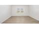 Well-lit bedroom with modern flooring, neutral paint and natural light at 680 Winesap Dr, Graham, NC 27253