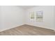 Bright bedroom featuring wood-look flooring and natural light from two windows at 680 Winesap Dr, Graham, NC 27253