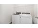 Laundry room featuring a white washer and dryer with wire shelving above at 680 Winesap Dr, Graham, NC 27253