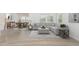 Bright living room featuring a gray sectional sofa, area rug, dining table, and modern decor at 680 Winesap Dr, Graham, NC 27253