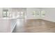 Bright open-concept space with wood-look flooring, neutral walls, and abundant natural light at 680 Winesap Dr, Graham, NC 27253