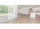 Open-concept living space flowing into the kitchen with island, featuring modern flooring and light at 680 Winesap Dr, Graham, NC 27253