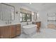 Elegant bathroom featuring double vanities, freestanding tub, and stylish tile flooring at 702 Wimbleton Dr, Raleigh, NC 27609