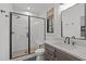 Modern bathroom with a glass-enclosed shower, stylish vanity, and updated fixtures at 702 Wimbleton Dr, Raleigh, NC 27609