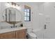 Bright bathroom featuring a glass-enclosed shower, modern fixtures, and stylish decor at 702 Wimbleton Dr, Raleigh, NC 27609