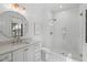 Elegant bathroom with marble floors, quartz countertops, glass enclosed shower and stylish fixtures at 702 Wimbleton Dr, Raleigh, NC 27609