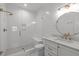 Elegant bathroom with white fixtures, quartz countertops, glass enclosed shower and stylish fixtures at 702 Wimbleton Dr, Raleigh, NC 27609