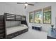 Charming bedroom featuring a bunk bed, natural light, and serene views at 702 Wimbleton Dr, Raleigh, NC 27609