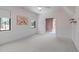 Cozy bedroom with wainscoting, two windows, and connecting room at 702 Wimbleton Dr, Raleigh, NC 27609