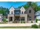 Stunning two-story home with stone accents, manicured landscaping, and classic architectural details at 702 Wimbleton Dr, Raleigh, NC 27609