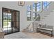 Light-filled foyer with a staircase, large windows, and a stylish entryway design at 702 Wimbleton Dr, Raleigh, NC 27609