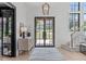 Bright foyer features large windows, stylish light fixtures, and elegant entryway details at 702 Wimbleton Dr, Raleigh, NC 27609