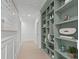 Bright hallway with custom built-in shelving providing ample storage and decorative display space at 702 Wimbleton Dr, Raleigh, NC 27609
