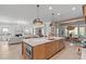 Open concept kitchen with a large island, views of the living and dining areas at 702 Wimbleton Dr, Raleigh, NC 27609