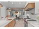 A designer kitchen with an island sink and breakfast bar is open to the dining area at 702 Wimbleton Dr, Raleigh, NC 27609