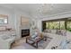 Elegant living room with fireplace, stylish decor, and sliding glass doors to outdoor space at 702 Wimbleton Dr, Raleigh, NC 27609