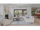 Spacious living room with a fireplace, large windows, and an open layout at 702 Wimbleton Dr, Raleigh, NC 27609