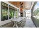 Covered outdoor dining area with stone floor, wood ceiling, fireplace, and white table at 702 Wimbleton Dr, Raleigh, NC 27609