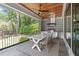 Covered outdoor kitchen and dining area with wood ceiling, stainless grill, and stone tile at 702 Wimbleton Dr, Raleigh, NC 27609