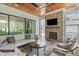 Cozy outdoor living area with a stone fireplace, comfortable seating, and serene views at 702 Wimbleton Dr, Raleigh, NC 27609