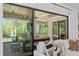 A view from the couch showing the covered outdoor patio with comfortable seating and nature views at 702 Wimbleton Dr, Raleigh, NC 27609