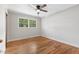 Bedroom features hardwood floors, neutral walls, and a ceiling fan at 717 Fairfield St, Burlington, NC 27215
