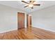 A bedroom featuring hardwood floors, ceiling fan and closet space at 717 Fairfield St, Burlington, NC 27215