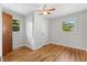 The bedroom boasts hardwood floors, two windows and ceiling fan at 717 Fairfield St, Burlington, NC 27215