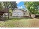 Two-car detached garage with white siding and roll-up doors, adjacent to backyard at 717 Fairfield St, Burlington, NC 27215