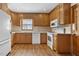 This kitchen features wood cabinets, countertops and white appliances at 717 Fairfield St, Burlington, NC 27215