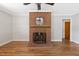 Cozy living room features a charming brick fireplace and hardwood floors at 717 Fairfield St, Burlington, NC 27215