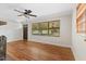 Bright living room boasts hardwood floors, ceiling fan, and views of the front yard at 717 Fairfield St, Burlington, NC 27215