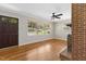 Living room featuring a brick fireplace, hardwood floors, and large windows at 717 Fairfield St, Burlington, NC 27215