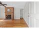 Living room offers hardwood floors, a fireplace, and a ceiling fan at 717 Fairfield St, Burlington, NC 27215