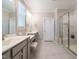 Luxurious bathroom with double vanity sinks, a glass-enclosed shower, and tile flooring at 725 Banningford Rd, Cary, NC 27518