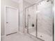 Bathroom featuring marble tile shower, bench, and glass door enclosure at 725 Banningford Rd, Cary, NC 27518