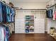 Walk-in closet with custom shelving and organizers with wood floors at 725 Banningford Rd, Cary, NC 27518